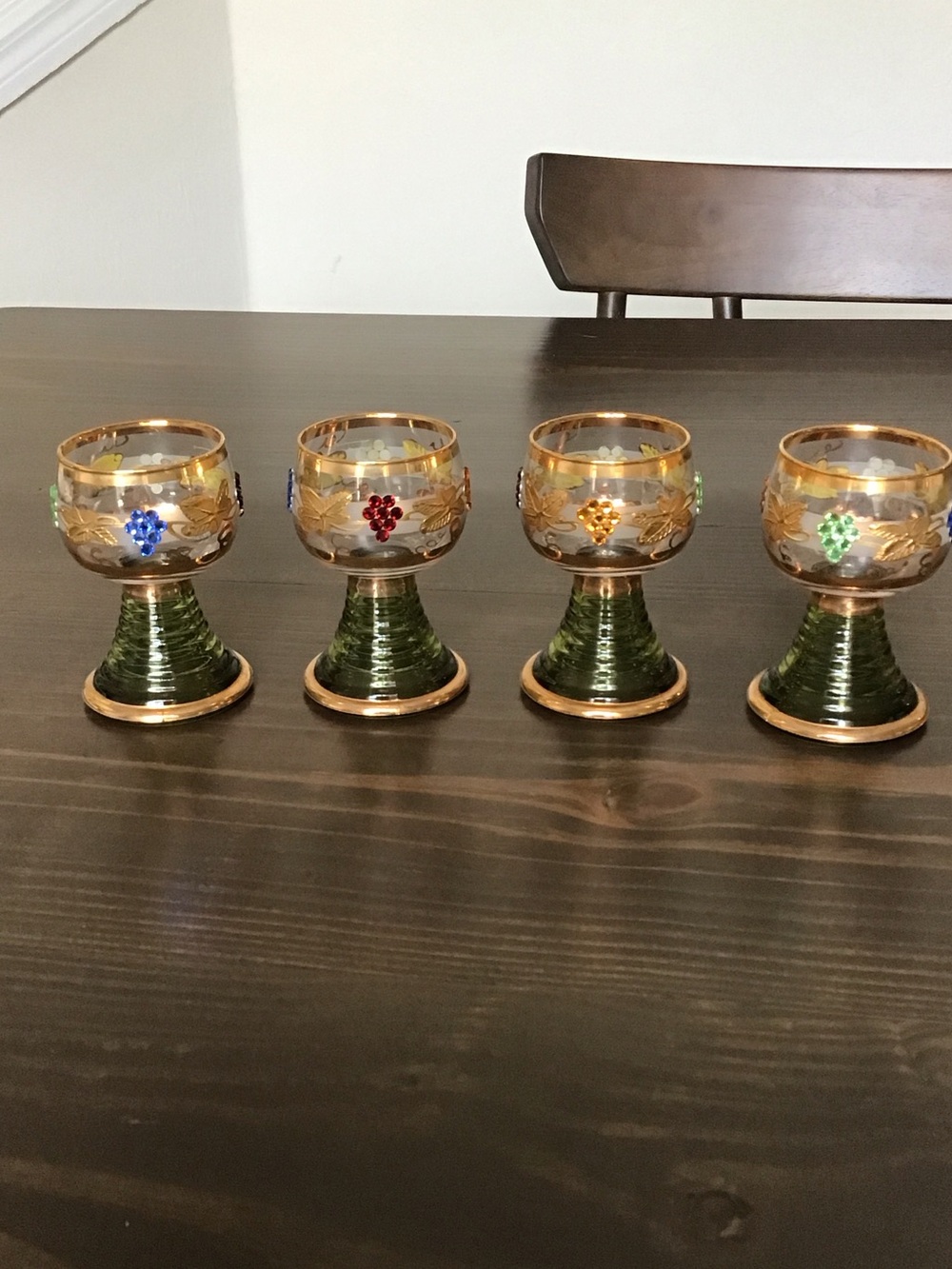 Vintage German Römer wine glasses featuring a distinct green "beehive" stem
